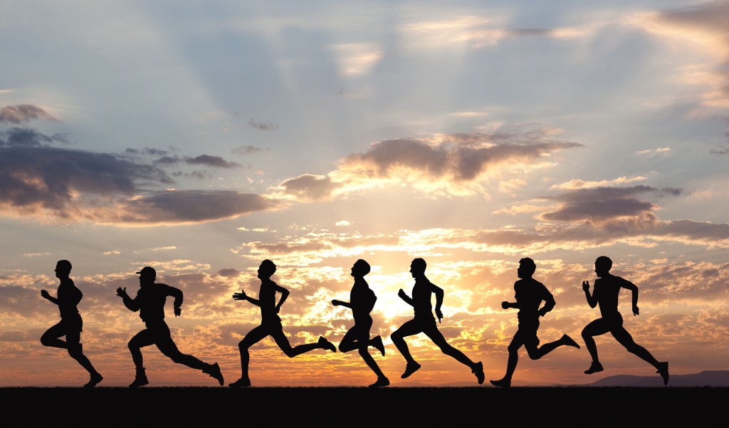 Marathon, black silhouettes of runners on the sunset